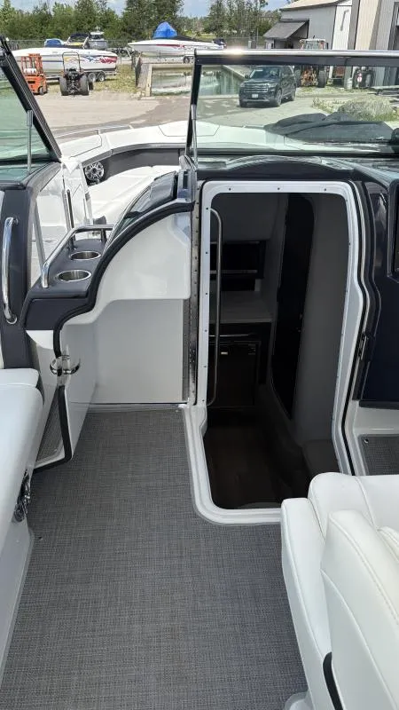 Slide: The Image of 2022 Formula 350 CBR boat interior with open cabin door, showcasing seating and cup holders. - 34