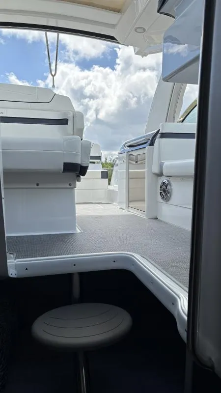 Slide: The Image of 2022 Formula 350 CBR boat interior with seating, under a partly cloudy sky. - 4