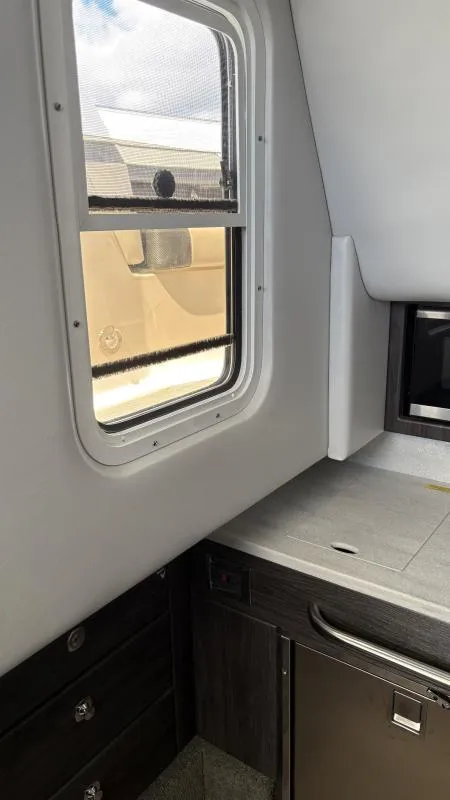 Slide: The Image of Interior view of 2022 Formula 350 CBR boat cabin with window and cabinetry. - 44