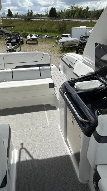 Slide: The Image of 2022 Formula 350 CBR boat interior with seating and kitchenette, parked outdoors. - 45