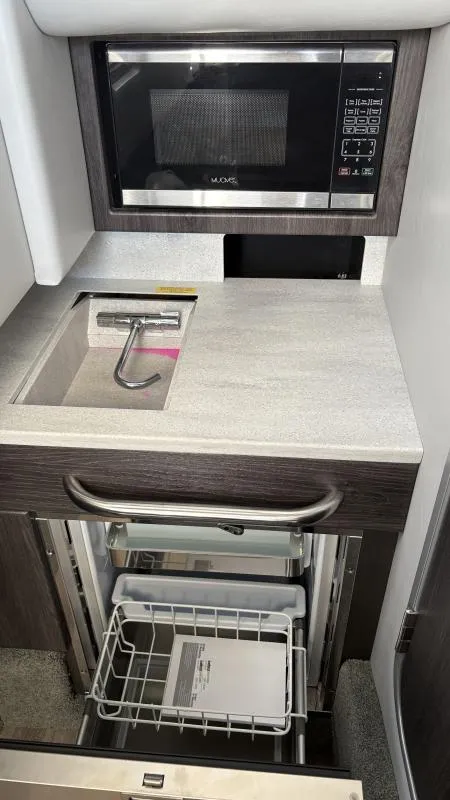 Slide: The Image of 2022 Formula 350 CBR boat kitchenette with microwave, sink, and storage drawers. - 48