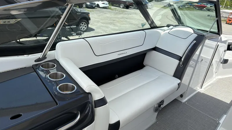 Slide: The Image of 2022 Formula 350 CBR boat interior with white seating and cup holders. - 49