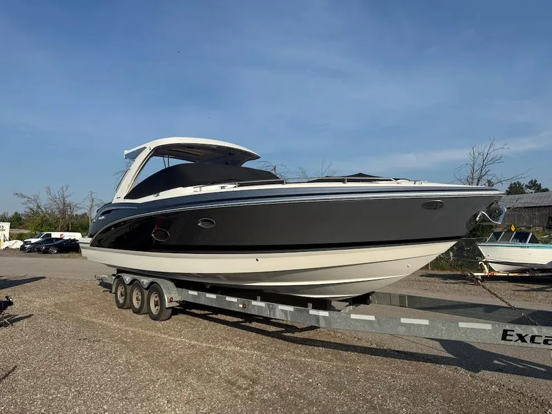 Slide: The Image of 2022 Formula 350 CBR boat on trailer under clear blue sky. - 50
