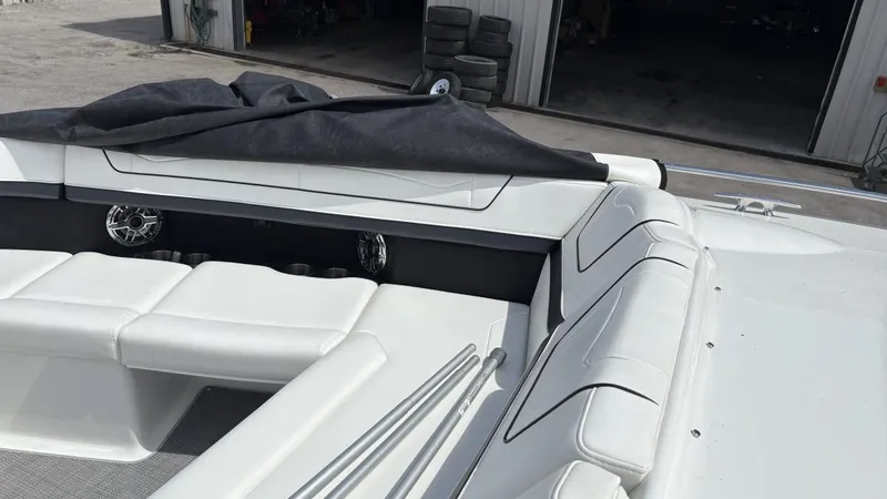 Slide: The Image of 2022 Formula 350 CBR boat interior with white seating and covered equipment. - 6