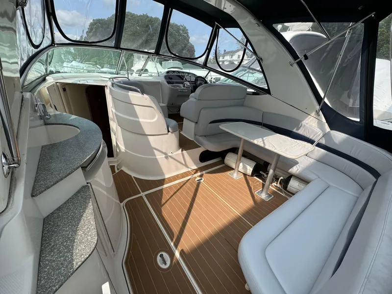 Slide: The Image of 2005 Chaparral Signature 350 yacht interior with seating, table, and kitchenette. - 4