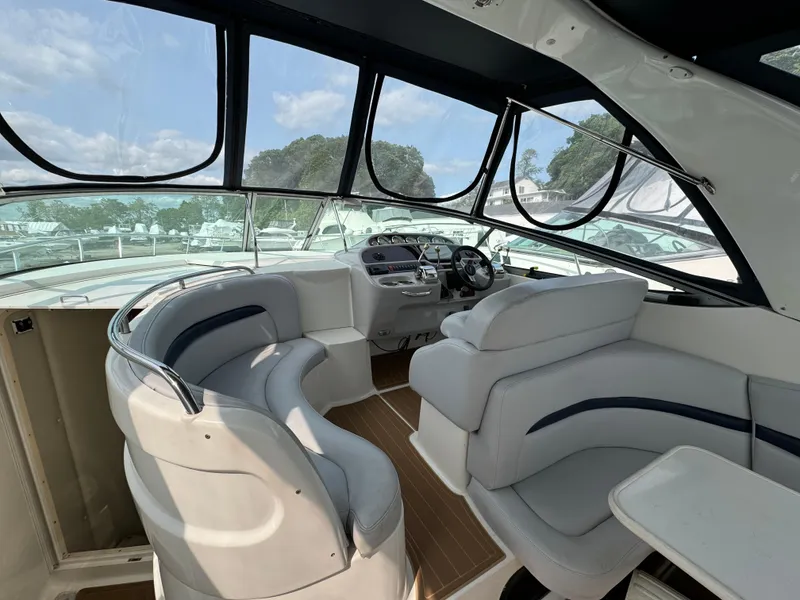 Slide: The Image of 2005 Chaparral Signature 350 boat interior with plush seating and modern dashboard. - 6
