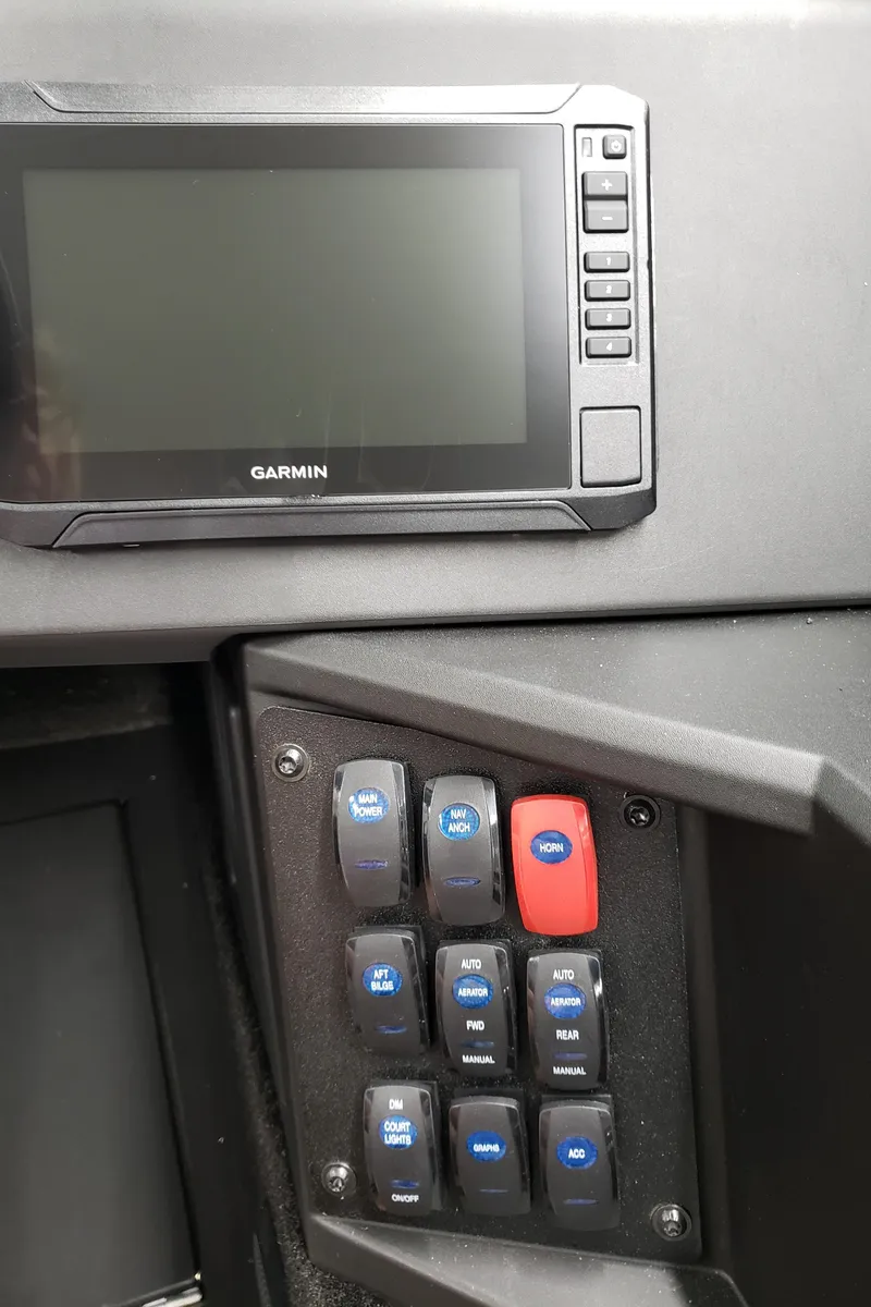 Slide: The Image of Control panel of 2025 Alumacraft Competitor 175X Sport with Garmin display and switches. - 19