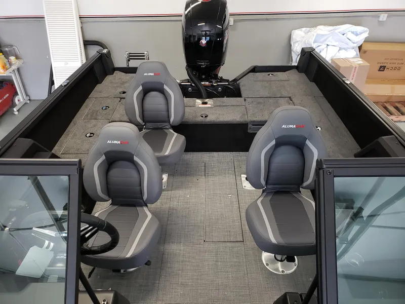 Slide: The Image of 2025 Alumacraft Competitor 175X Sport boat interior with four seats and motor. - 4