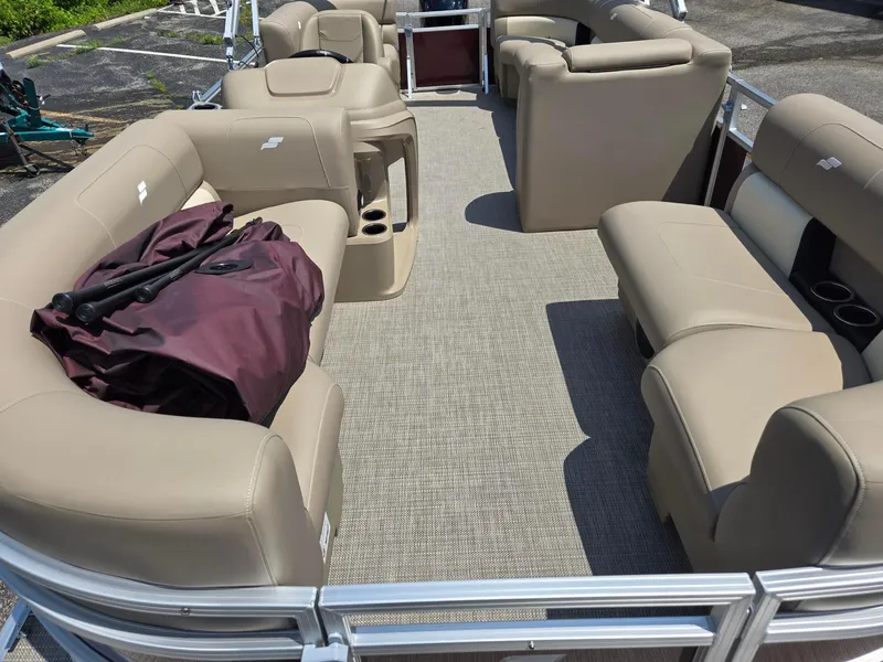 Slide: The Image of Interior of a 2026 Starcraft LX20R pontoon boat with beige seating and carpet. - 5