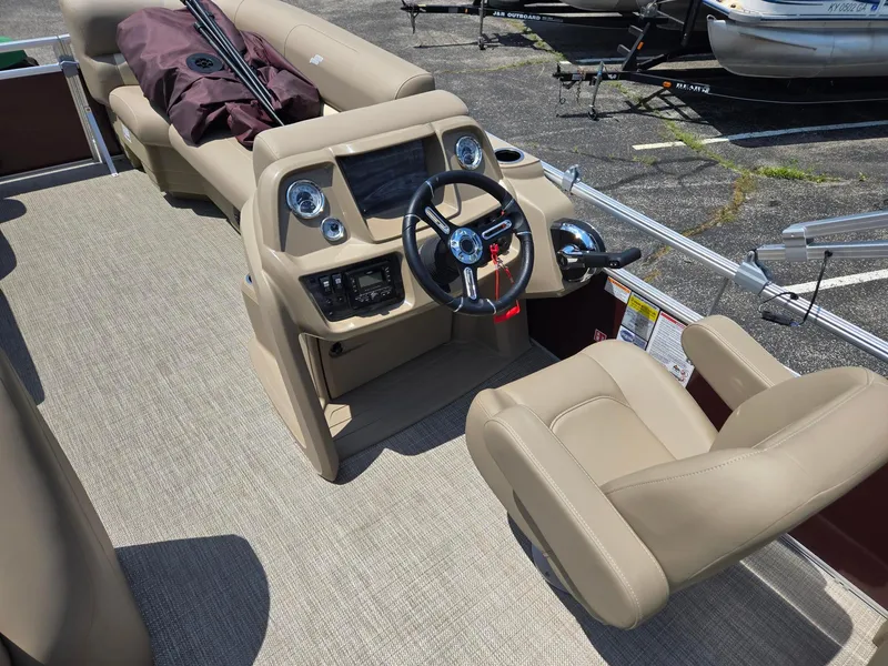 Slide: The Image of 2026 Starcraft LX20R boat interior with beige seating, steering wheel, and control panel. - 9