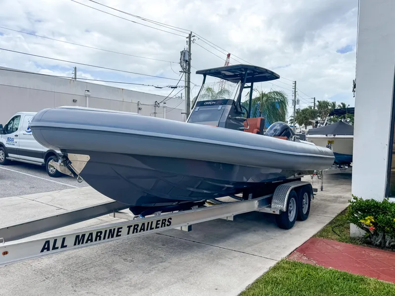Slide: The Image of 2023 Northstar Orion 7 boat on trailer, parked outdoors near a building. - 11