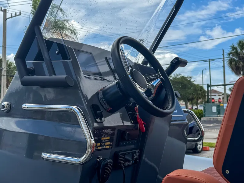 Slide: The Image of 2023 Northstar Orion 7 boat dashboard with steering wheel and controls. - 3