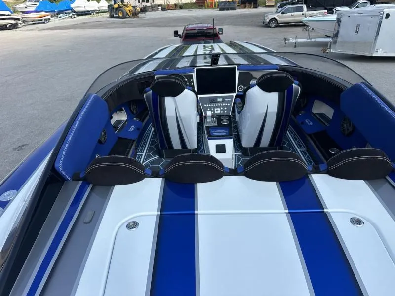 Slide: The Image of 2018 Wright Performance 420 boat interior with blue and white seating and advanced dashboard controls. - 10