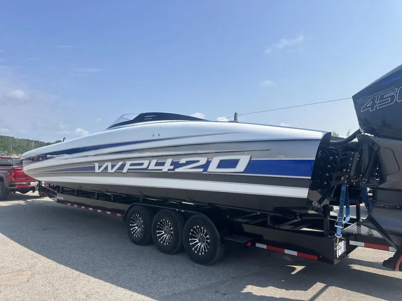Slide: The Image of 2018 Wright Performance 420 boat on trailer, sleek design, blue and white accents. - 33