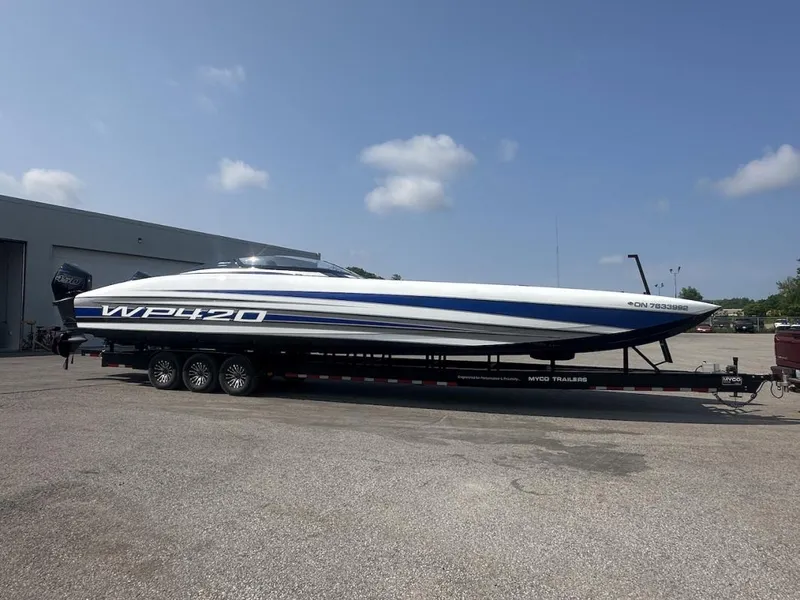 Slide: The Image of 2018 Wright Performance 420 boat on trailer, parked outdoors under a clear sky. - 34
