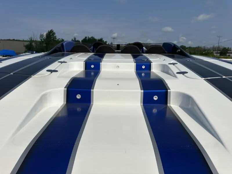 Slide: The Image of 2018 Wright Performance 420 boat with sleek blue and white design, viewed from the rear. - 9