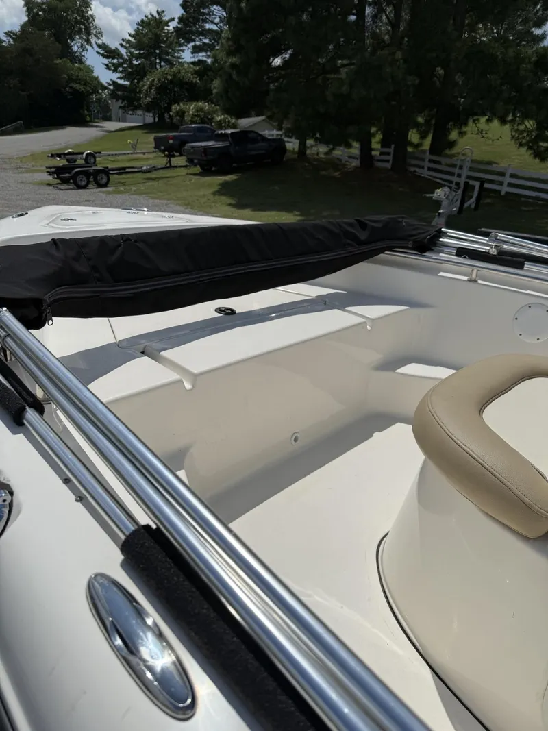 Slide: The Image of 2018 Key West 189 FS boat interior with seating and railings, parked outdoors. - 2