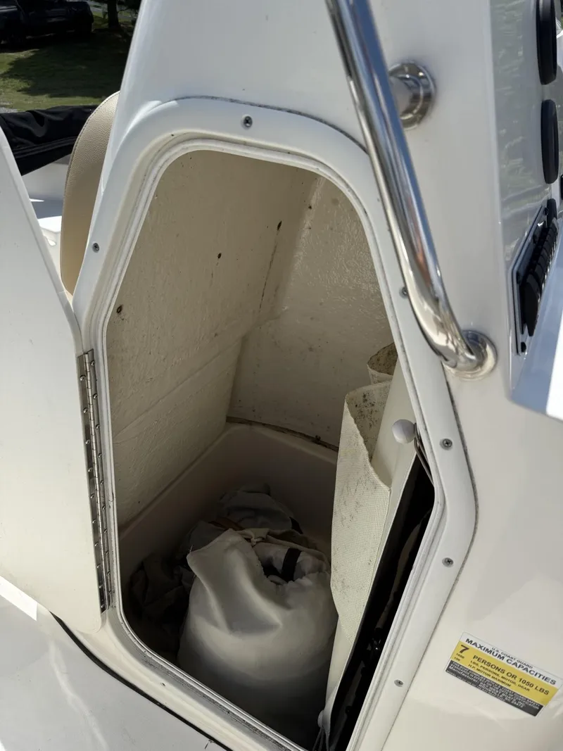 Slide: The Image of 2018 Key West 189 FS boat storage compartment with open door, showing interior space. - 4