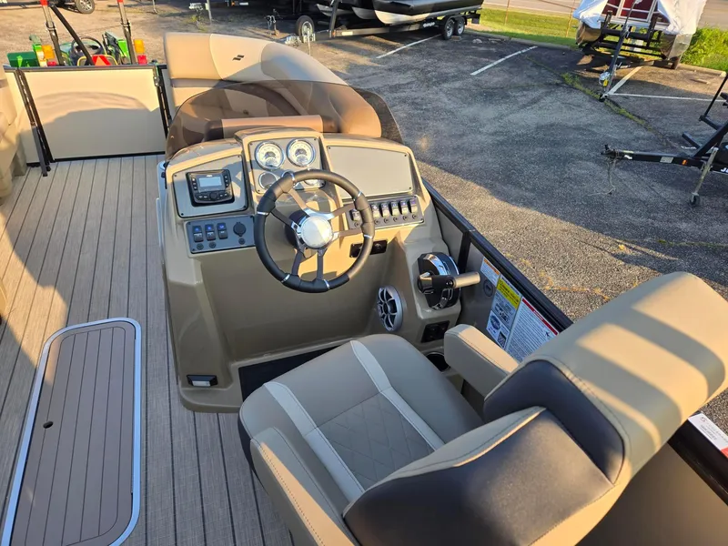 Slide: The Image of 2026 Starcraft EXS3DL boat interior with steering wheel, dashboard, and seating. - 11