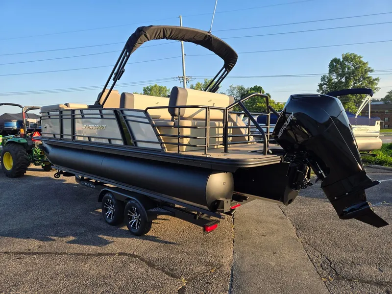 Slide: The Image of 2026 Starcraft EXS3DL pontoon boat with Mercury outboard motor, parked on a trailer. - 3