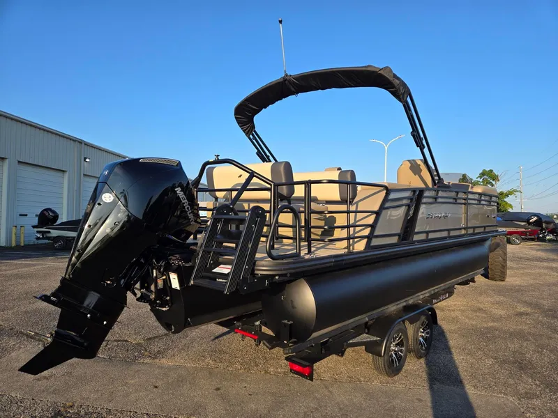 Slide: The Image of 2026 Starcraft EXS3DL pontoon boat with Mercury outboard engine, parked outdoors. - 4