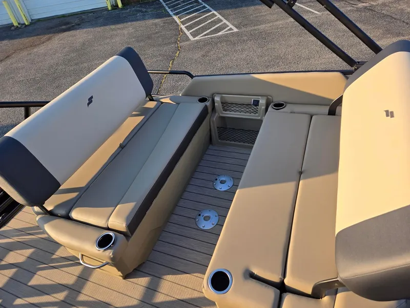 Slide: The Image of 2026 Starcraft EXS3DL boat interior with beige seating and cup holders. - 8