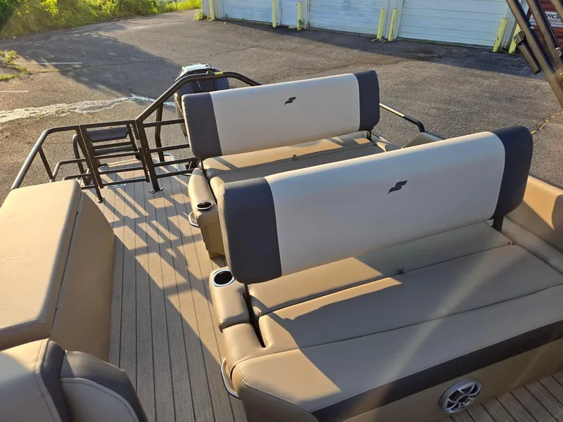 Slide: The Image of 2026 Starcraft EXS3DL boat interior with beige seating and cup holders. - 9