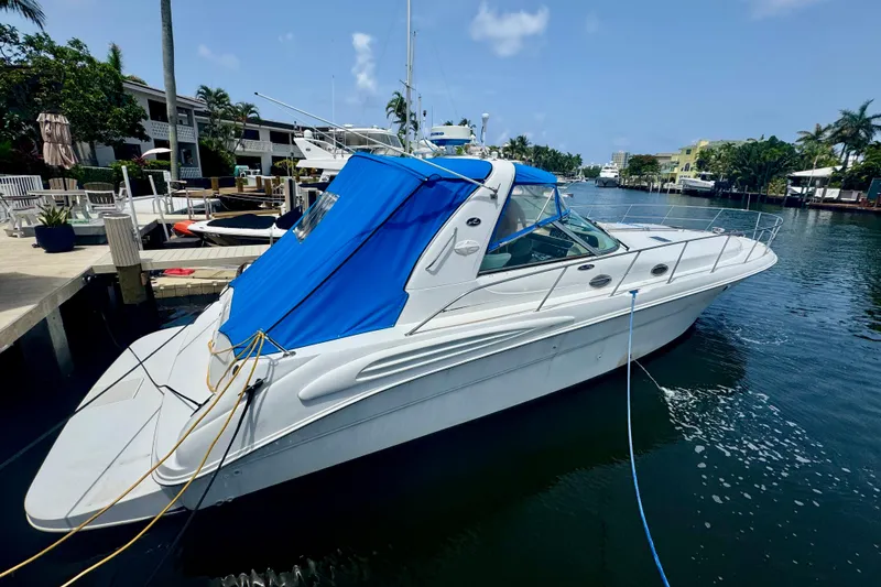 The Image of 1999 Sea Ray 400 Sundancer yacht docked in a scenic marina. - 0