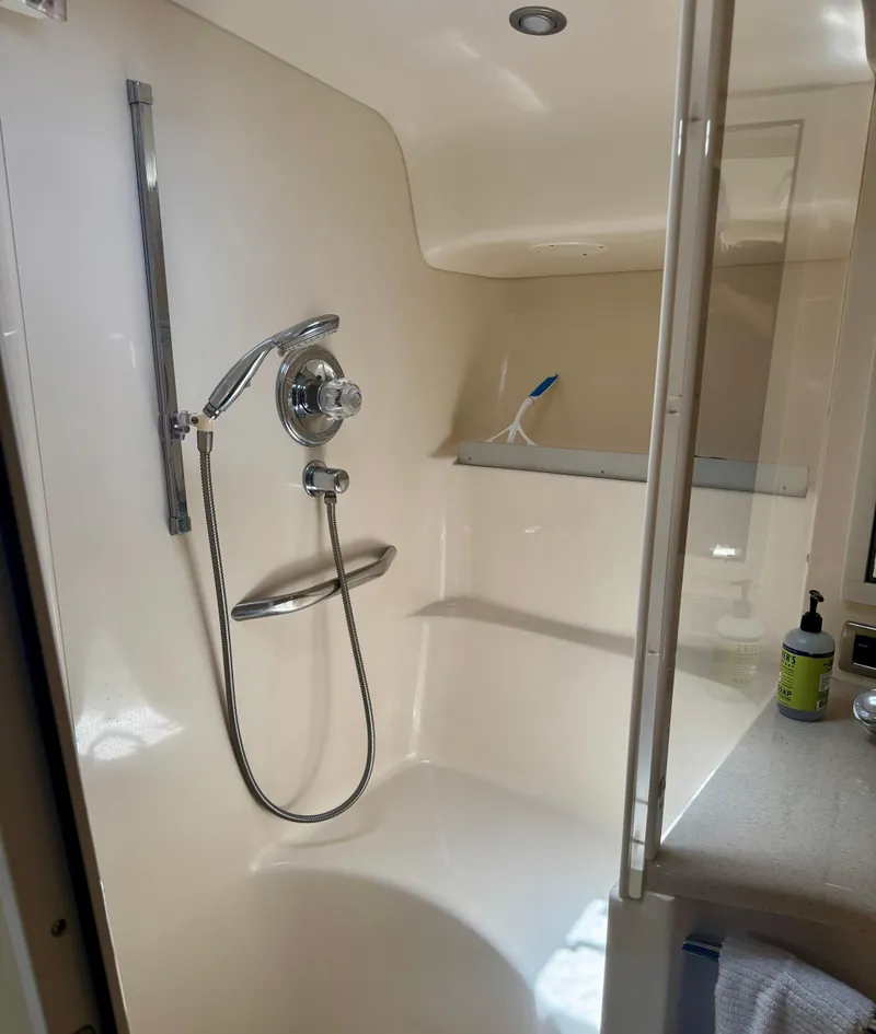 Slide: The Image of Shower area inside a 1999 Sea Ray 400 Sundancer yacht, featuring modern fixtures. - 11