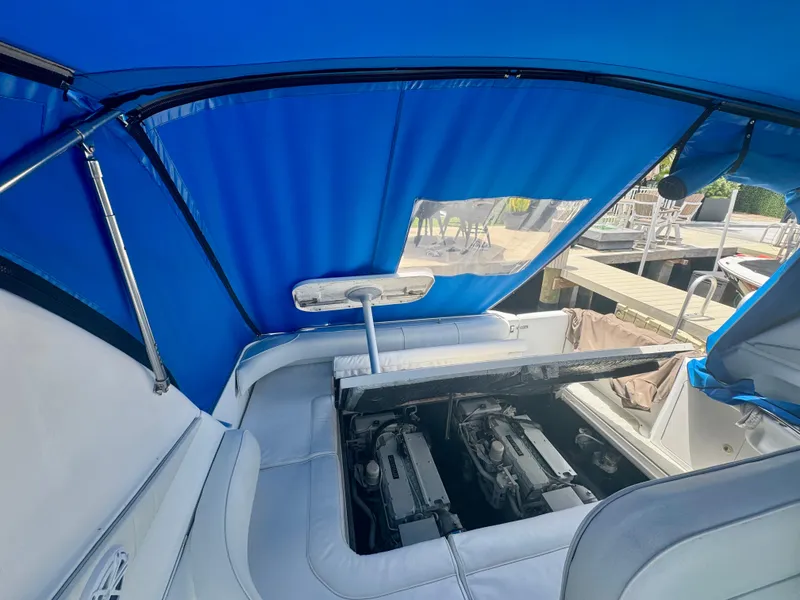 Slide: The Image of 1999 Sea Ray 400 Sundancer engine compartment under blue canopy. - 2