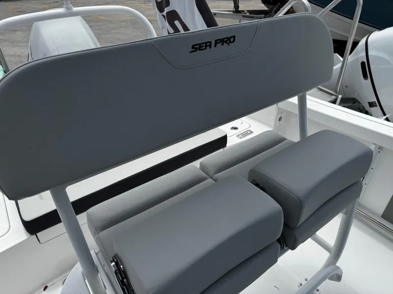 Slide: The Image of 2025 Sea Pro 225 Sandbar boat seating with gray cushions and sleek design. - 14
