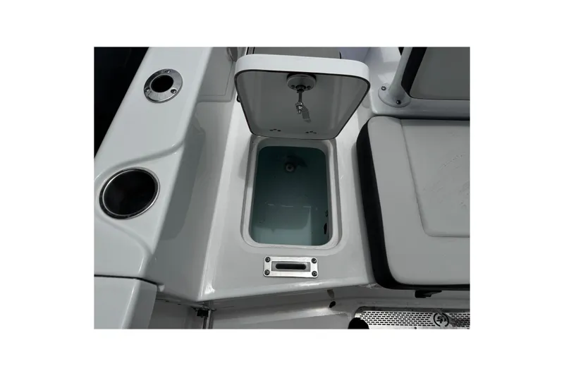 Slide: The Image of Open storage compartment on 2025 Sea Pro 225 Sandbar boat, featuring cup holders and sleek design. - 20