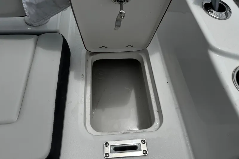 Slide: The Image of 2025 Sea Pro 225 Sandbar boat interior storage compartment and seating area. - 21