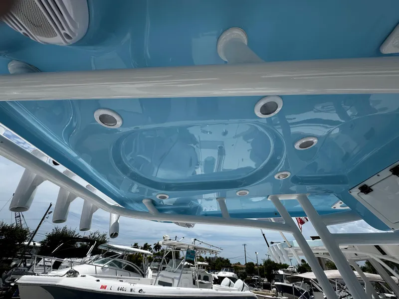 Slide: The Image of 2025 Sea Pro 225 Sandbar boat with blue interior ceiling and rod holders. - 30