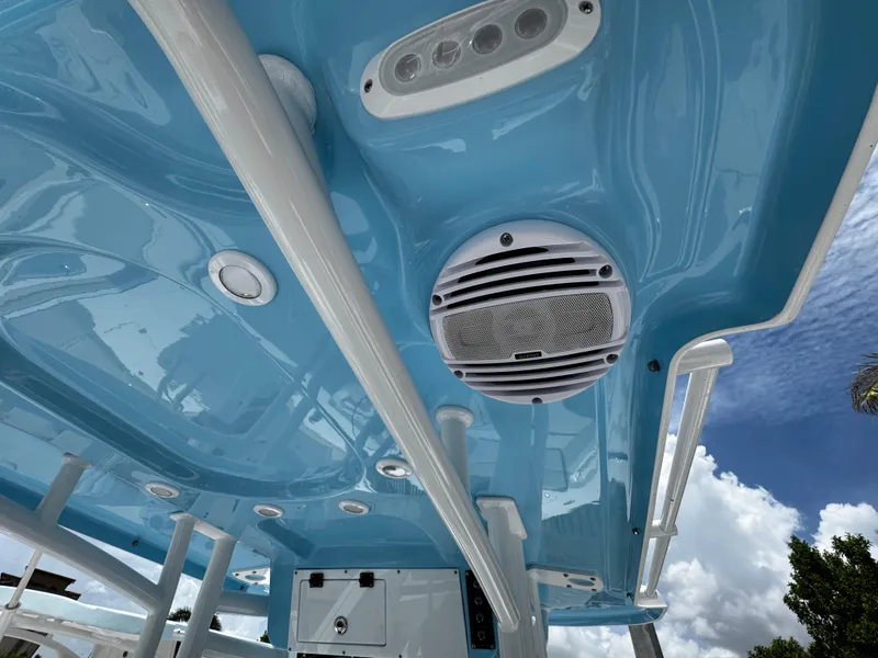 Slide: The Image of 2025 Sea Pro 225 Sandbar boat interior with blue ceiling, speaker, and LED lights. - 31