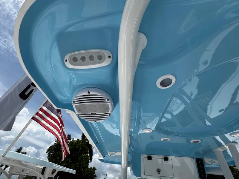 Slide: The Image of 2025 Sea Pro 225 Sandbar boat with blue interior and American flag. - 32