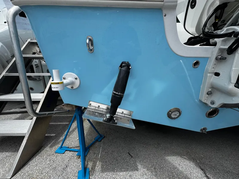 Slide: The Image of 2025 Sea Pro 225 Sandbar boat on stand, showing rear hull and trim tab. - 4