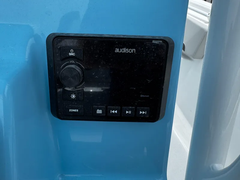 Slide: The Image of Audio control panel on 2025 Sea Pro 225 Sandbar boat, featuring volume and playback buttons. - 9