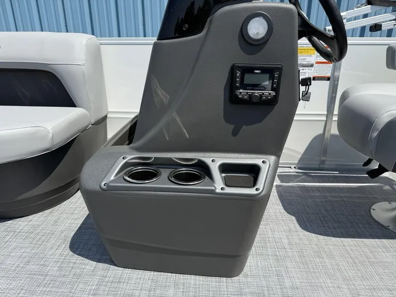 Slide: The Image of 2026 Sun Tracker PARTY BARGE® 16 DLX console with cup holders and control panel. - 11