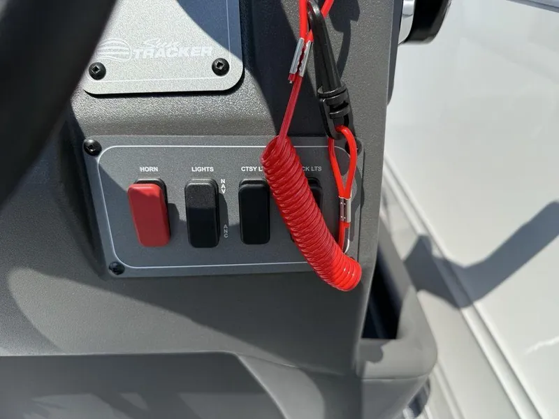 Slide: The Image of Control panel of 2026 Sun Tracker PARTY BARGE® 16 DLX with switches and safety lanyard. - 13