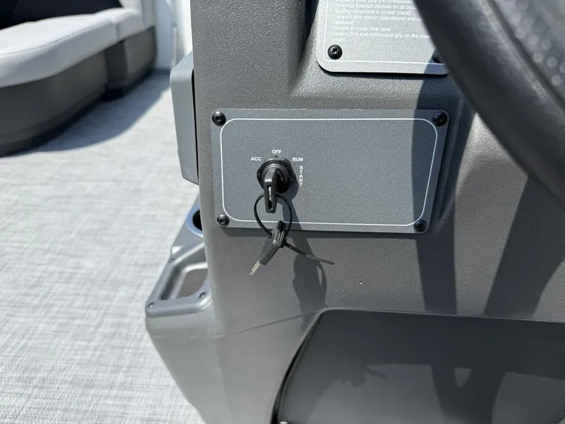 Slide: The Image of 2026 Sun Tracker PARTY BARGE® 16 DLX ignition switch with key inserted. - 19