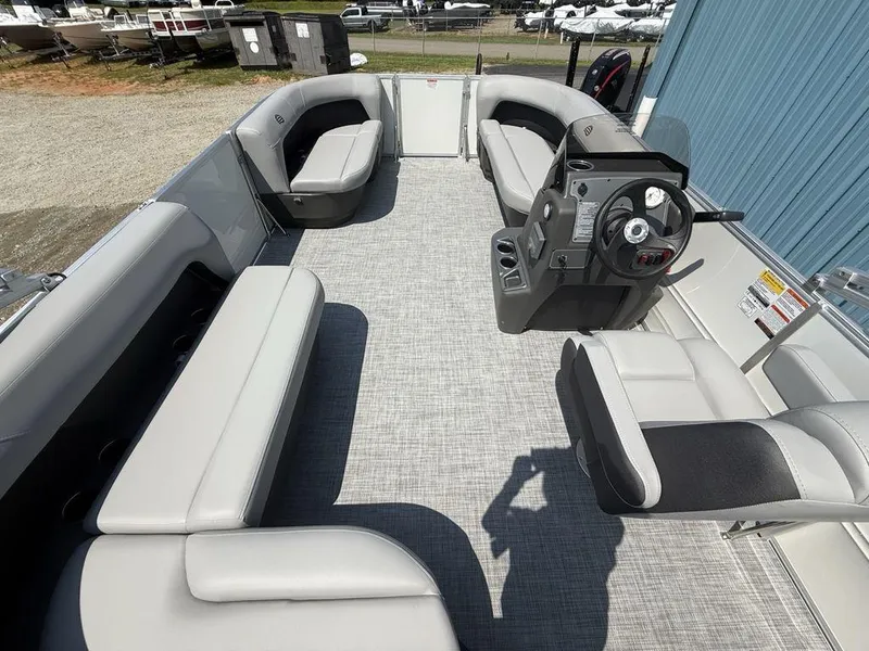 Slide: The Image of 2026 Sun Tracker PARTY BARGE® 16 DLX interior with spacious seating and modern helm. - 20