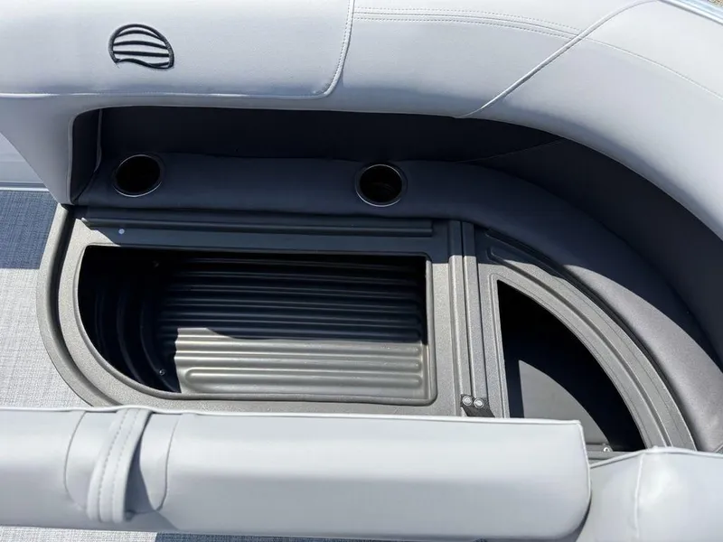 Slide: The Image of 2026 Sun Tracker PARTY BARGE® 16 DLX storage compartment with cup holders and sleek design. - 5