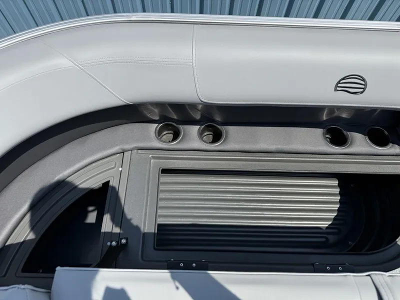 Slide: The Image of 2026 Sun Tracker PARTY BARGE® 16 DLX interior with cup holders and storage compartment. - 6