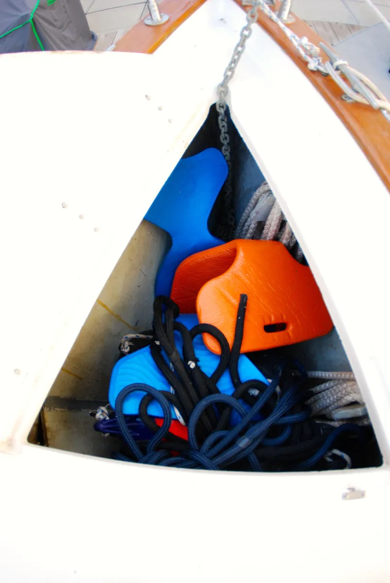 Slide: The Image of Storage compartment on 1985 Endeavour 38 sailboat with colorful fenders and ropes. - 11