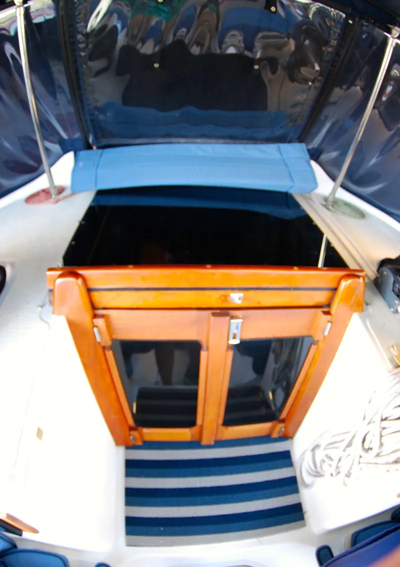 Slide: The Image of 1985 Endeavour 38 sailboat cockpit with wooden hatch and striped mat. - 17