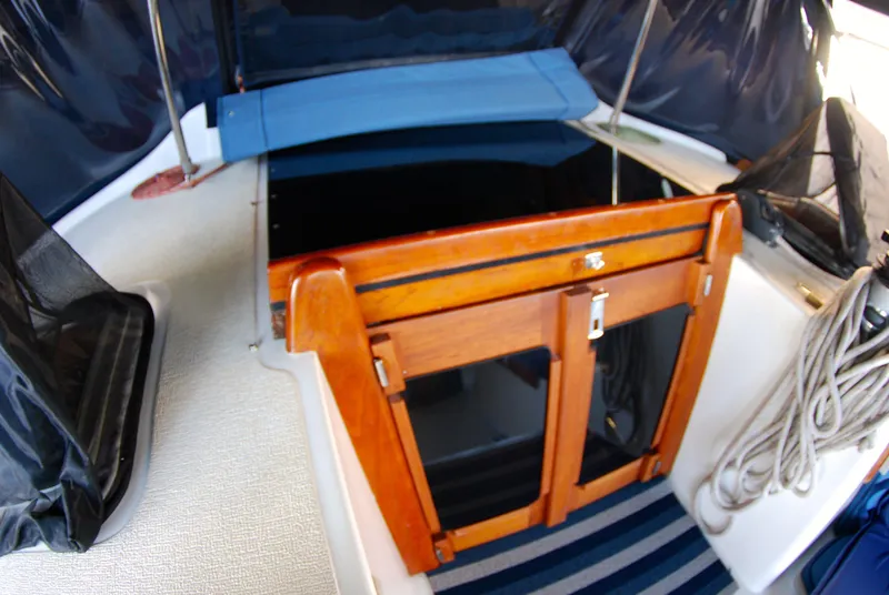 Slide: The Image of 1985 Endeavour 38 sailboat cockpit with wooden hatch and striped flooring. - 18