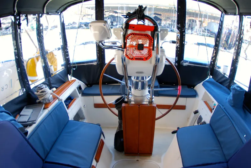 Slide: The Image of Interior of 1985 Endeavour 38 sailboat cockpit with blue seating and steering wheel. - 19