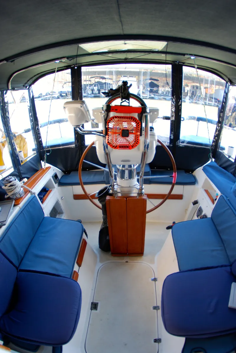 Slide: The Image of Interior view of 1985 Endeavour 38 sailboat cockpit with blue seating and steering wheel. - 20