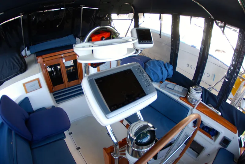 Slide: The Image of Interior of 1985 Endeavour 38 sailboat cockpit with navigation equipment and seating. - 24